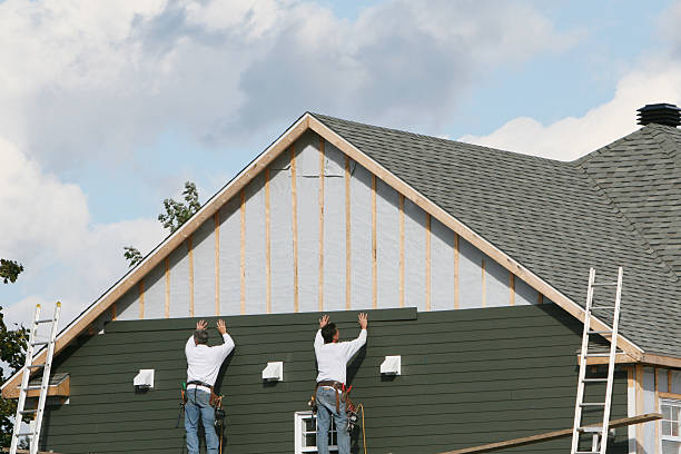 Professional Siding technician working in Slickville, PA